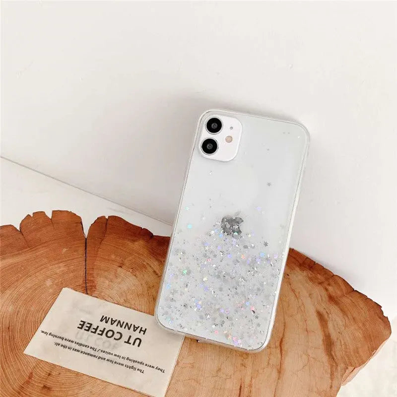 Transparent glitter epoxy soft shell case for Apple iPhone on a table.