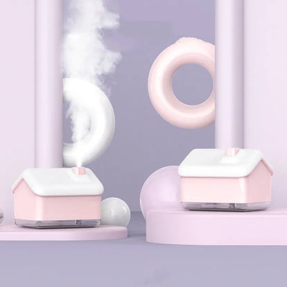 White igloo-shaped ultrasonic humidifier and essential oil diffuser with LED light on a wooden table.