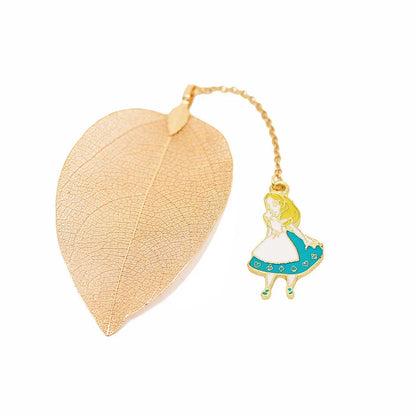 KC alloy metal bookmark with leaf, Alice, rabbit, and clock charms on an open book.