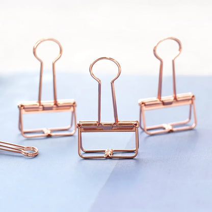 Rose gold metal binder set showing small and large sizes for ticket and paper organisation