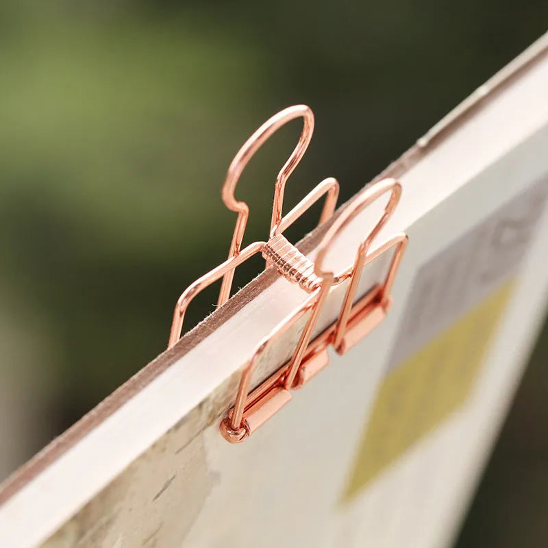 Rose gold metal binder set showing small and large sizes for ticket and paper organisation