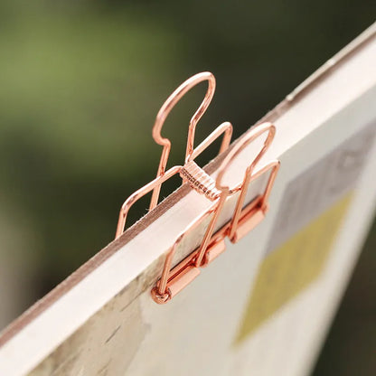 Rose gold metal binder set showing small and large sizes for ticket and paper organisation