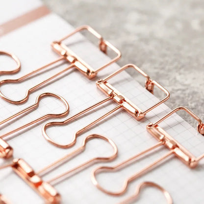 Rose gold metal binder set showing small and large sizes for ticket and paper organisation