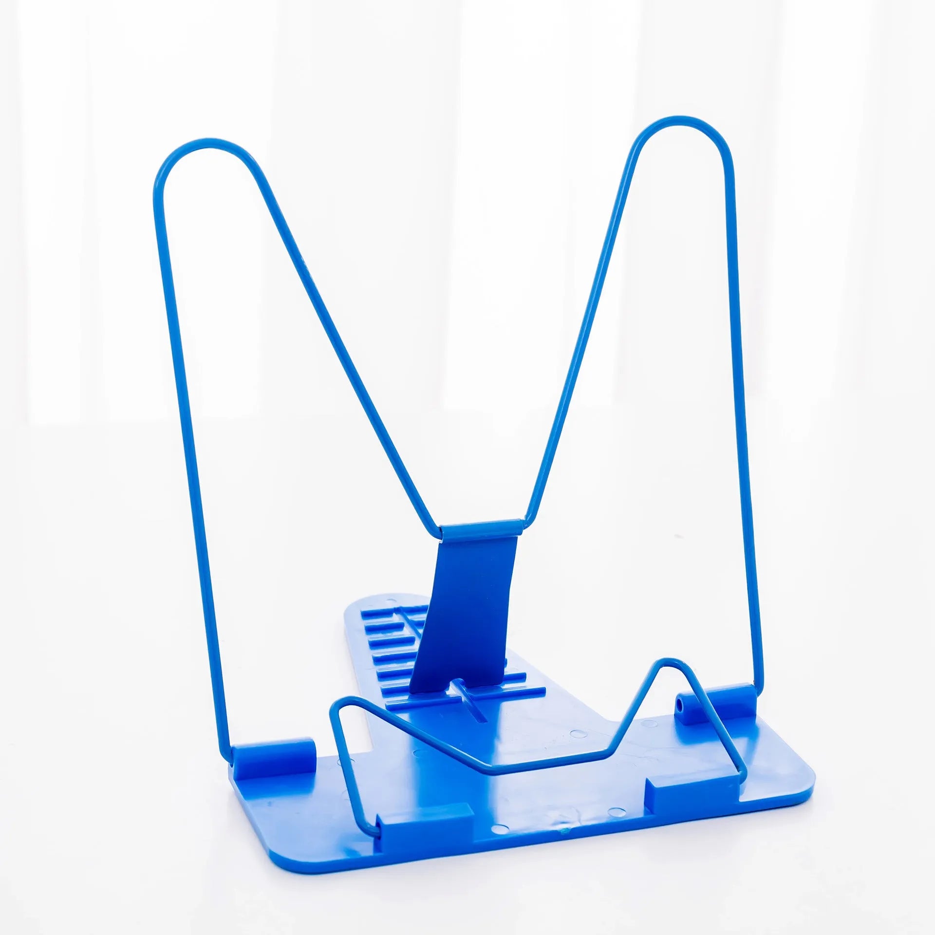 Reading frame holding a book at an upright angle with metal and plastic construction
