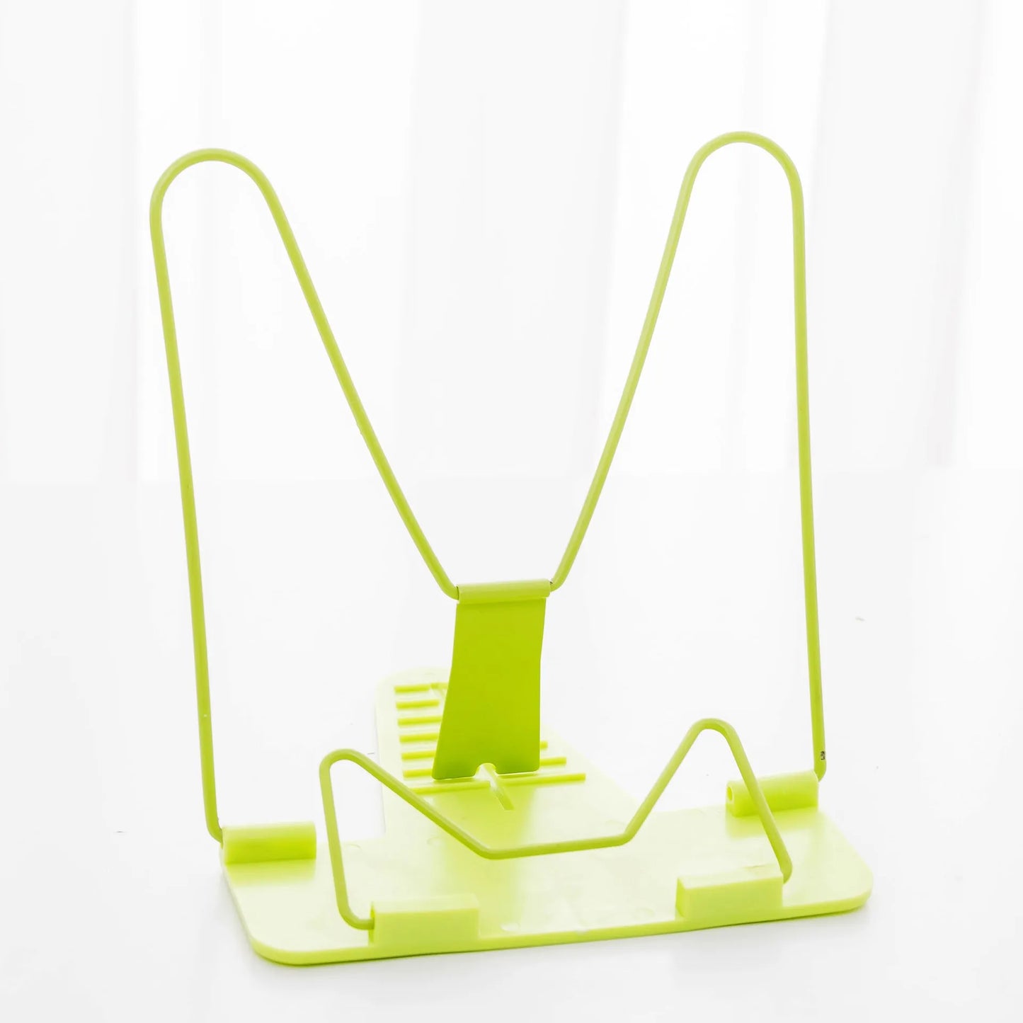 Reading frame holding a book at an upright angle with metal and plastic construction