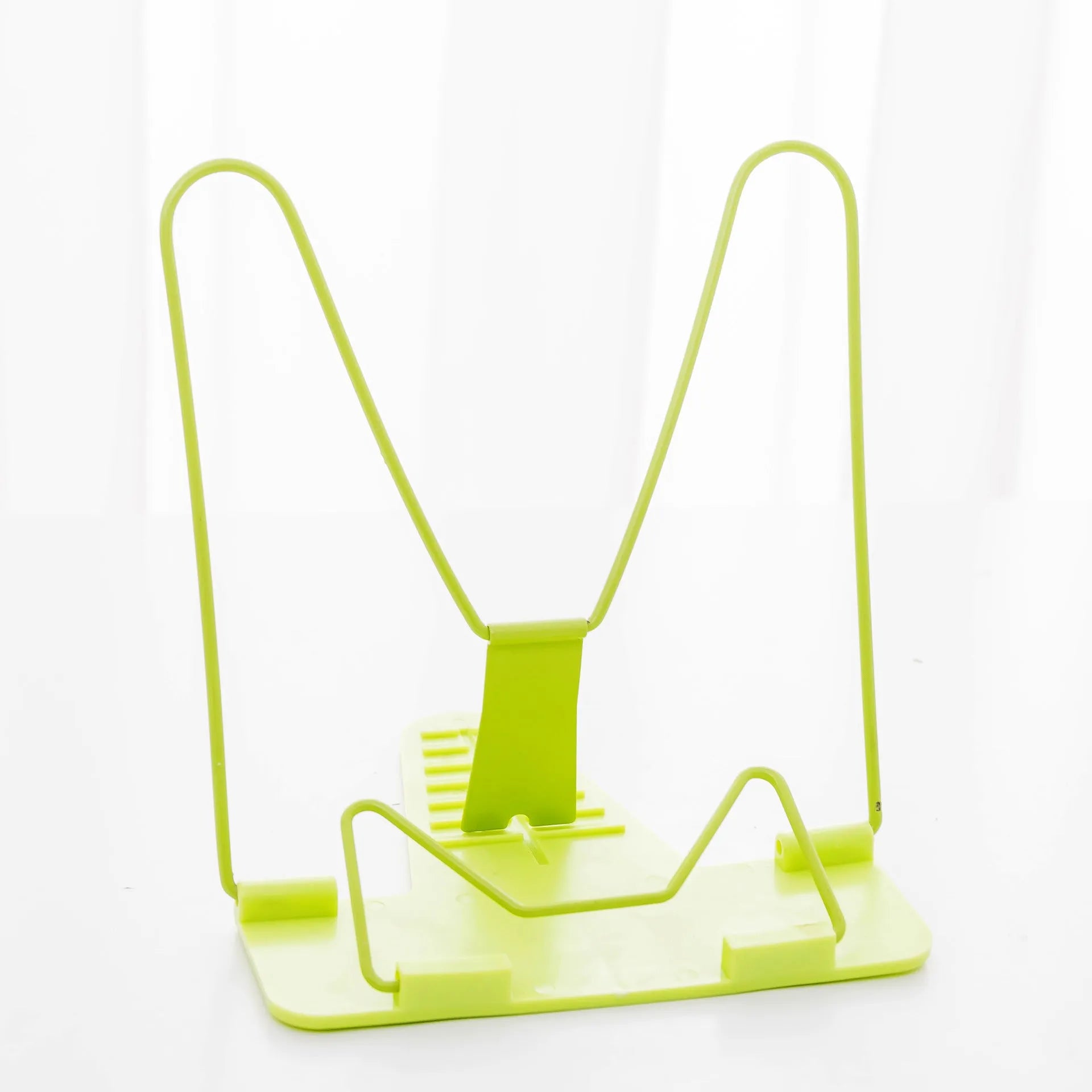 Reading frame holding a book at an upright angle with metal and plastic construction