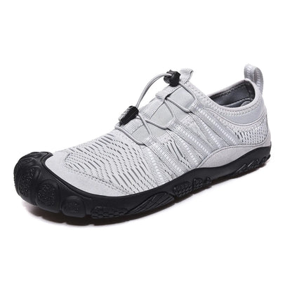 Unisex black outdoor wading shoe with mesh upper and rubber sole on rocky ground.