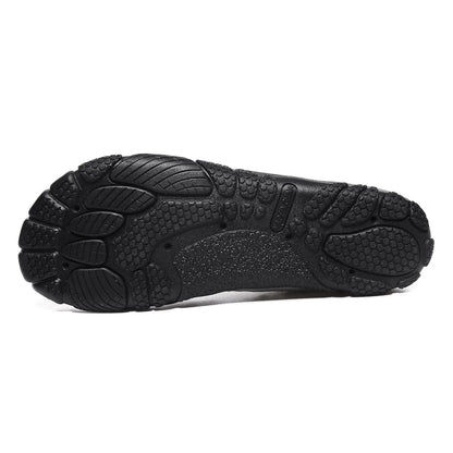Unisex black outdoor wading shoe with mesh upper and rubber sole on rocky ground.