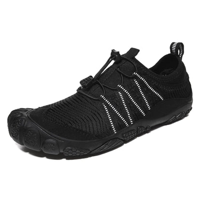 Unisex black outdoor wading shoe with mesh upper and rubber sole on rocky ground.