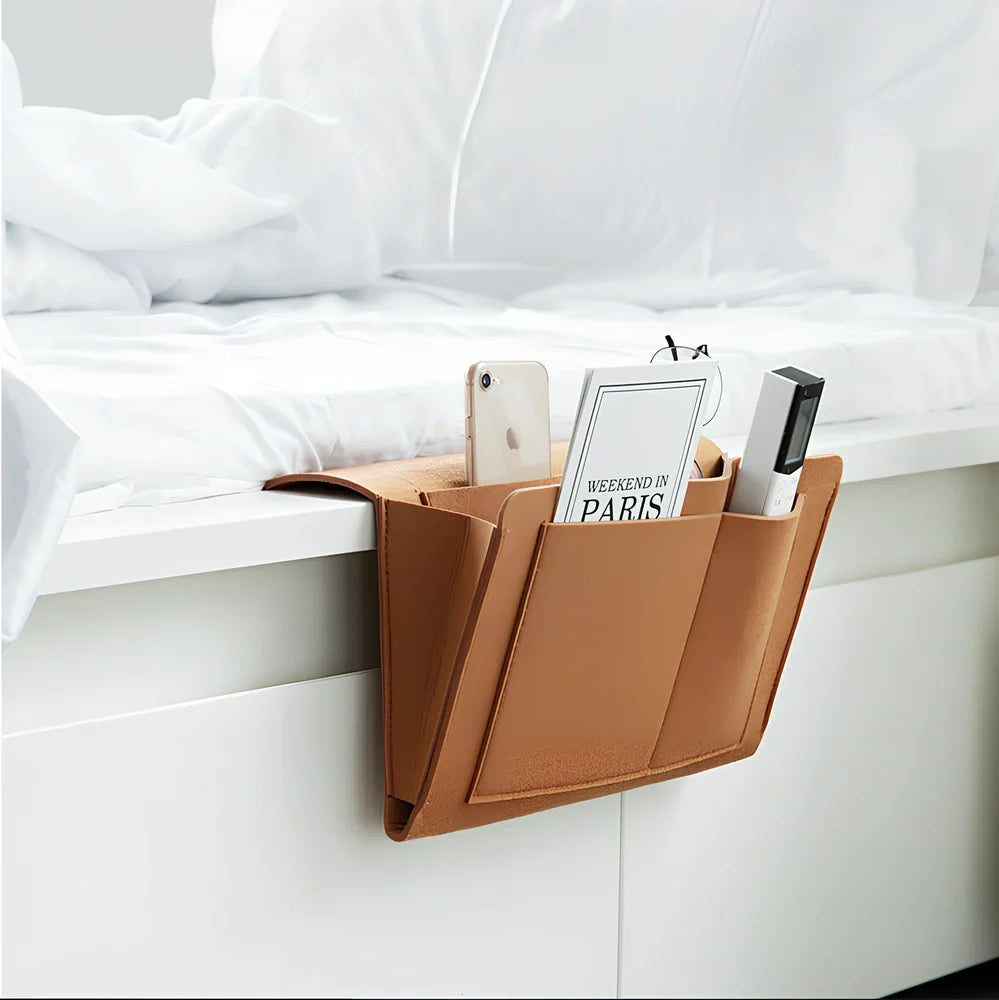 Felt bedside storage bag measuring 30x20x10cm with multiple pockets for remote controls and books
