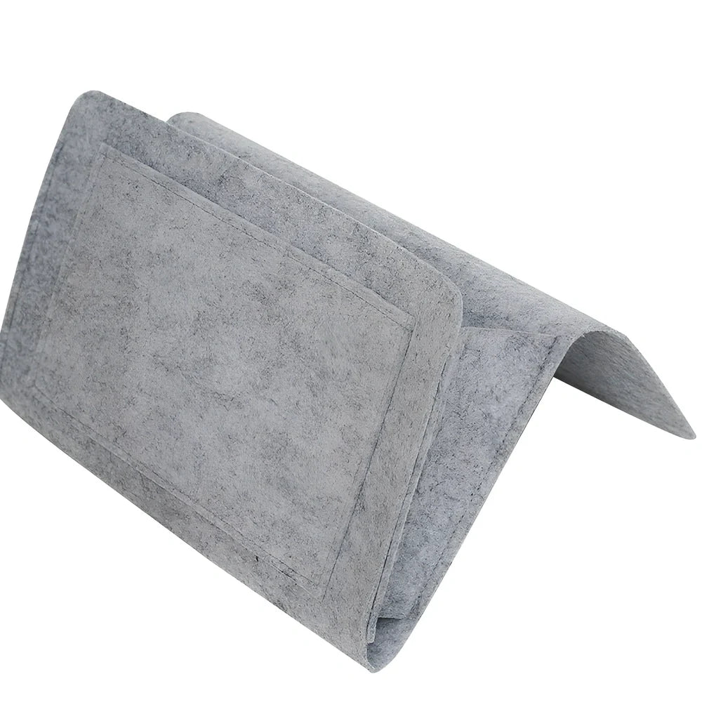 Felt bedside storage bag measuring 30x20x10cm with multiple pockets for remote controls and books
