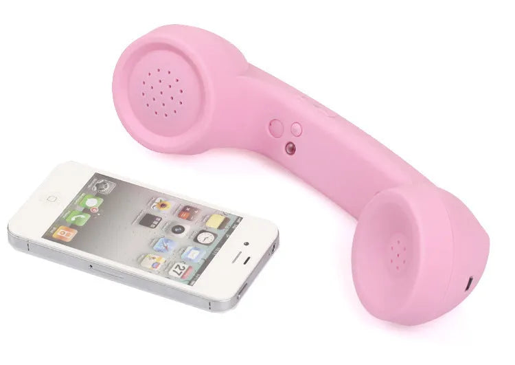 Retro-style Bluetooth wireless headset in hand, showing classic phone handset design and ear hook.