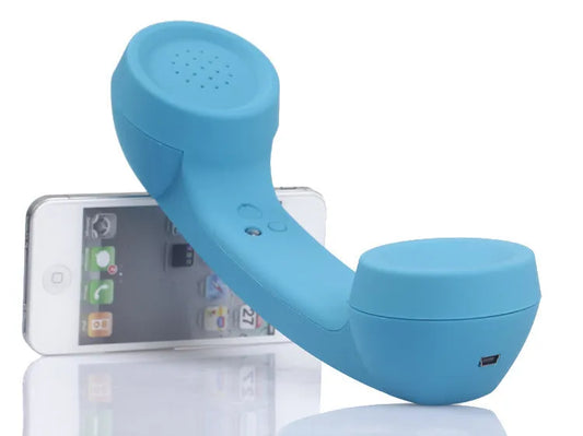 Retro-style Bluetooth wireless headset in hand, showing classic phone handset design and ear hook.