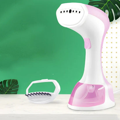 Pink and green portable garment steamer with brush attachment and 0.9-1.3L water tank capacity