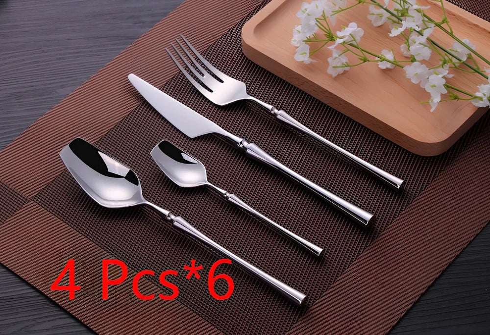 Four-piece stainless steel cutlery set showing main knife, fork, spoon, and teaspoon with mirror finish