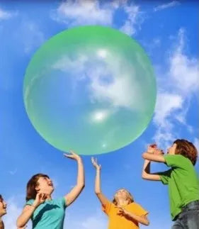 Large pink, yellow, green, and blue inflatable bouncy balls in various sizes for children's play.
