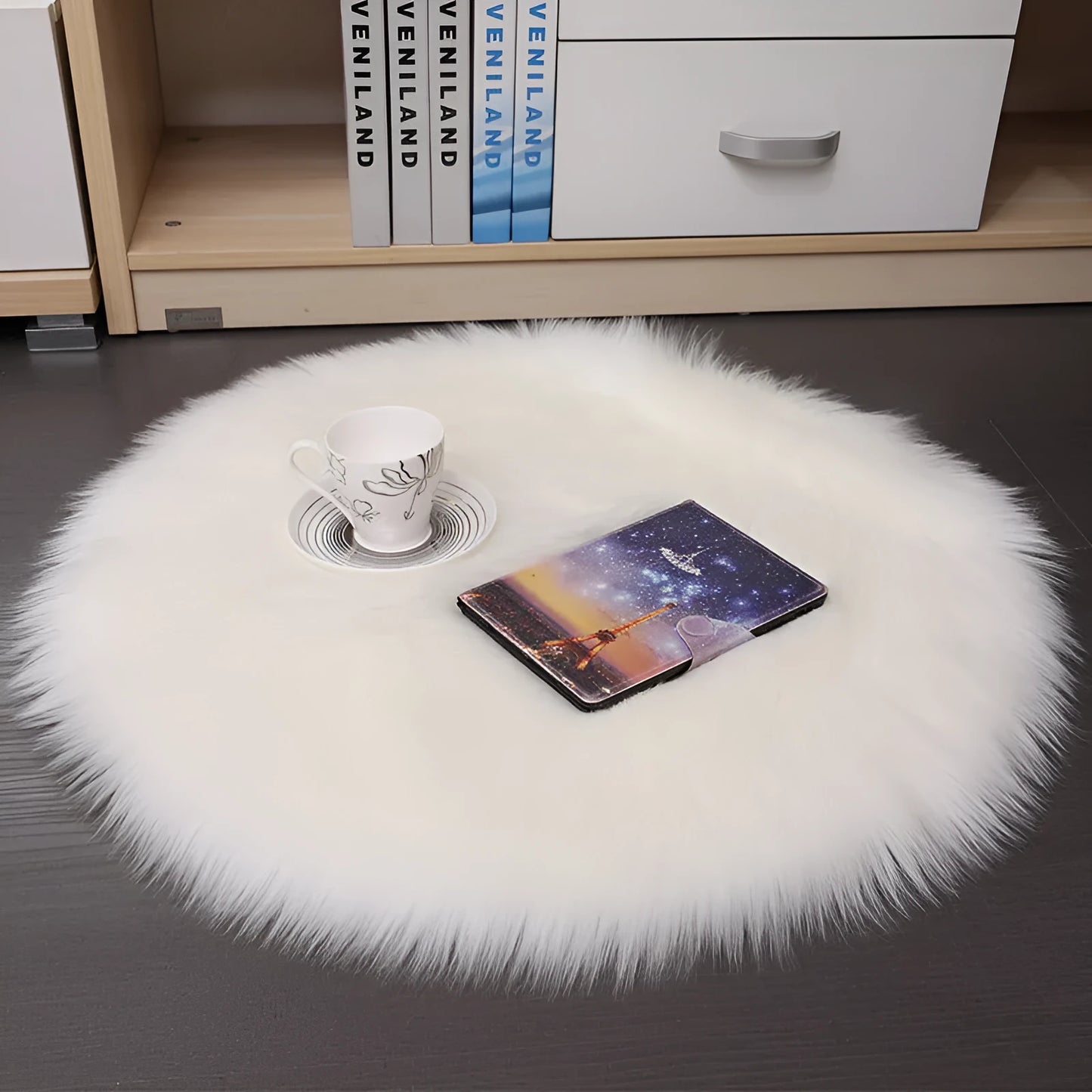 Round plush wool carpet in beige colour on a wooden floor.