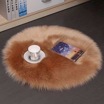 Round plush wool carpet in beige colour on a wooden floor.