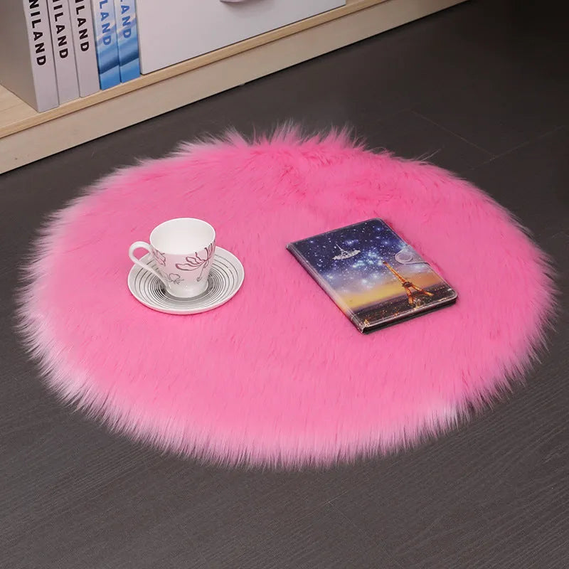 Round plush wool carpet in beige colour on a wooden floor.
