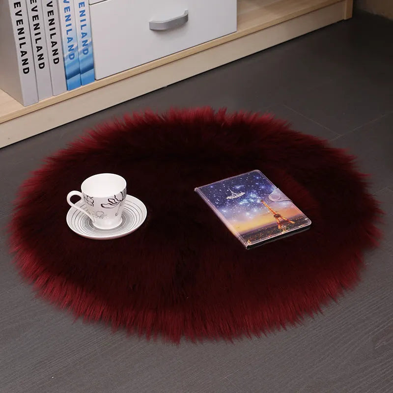 Round plush wool carpet in beige colour on a wooden floor.