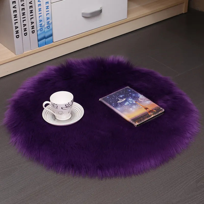 Round plush wool carpet in beige colour on a wooden floor.