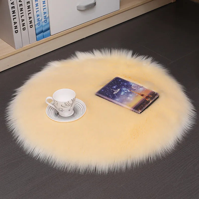 Round plush wool carpet in beige colour on a wooden floor.