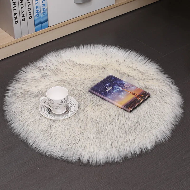 Round plush wool carpet in beige colour on a wooden floor.