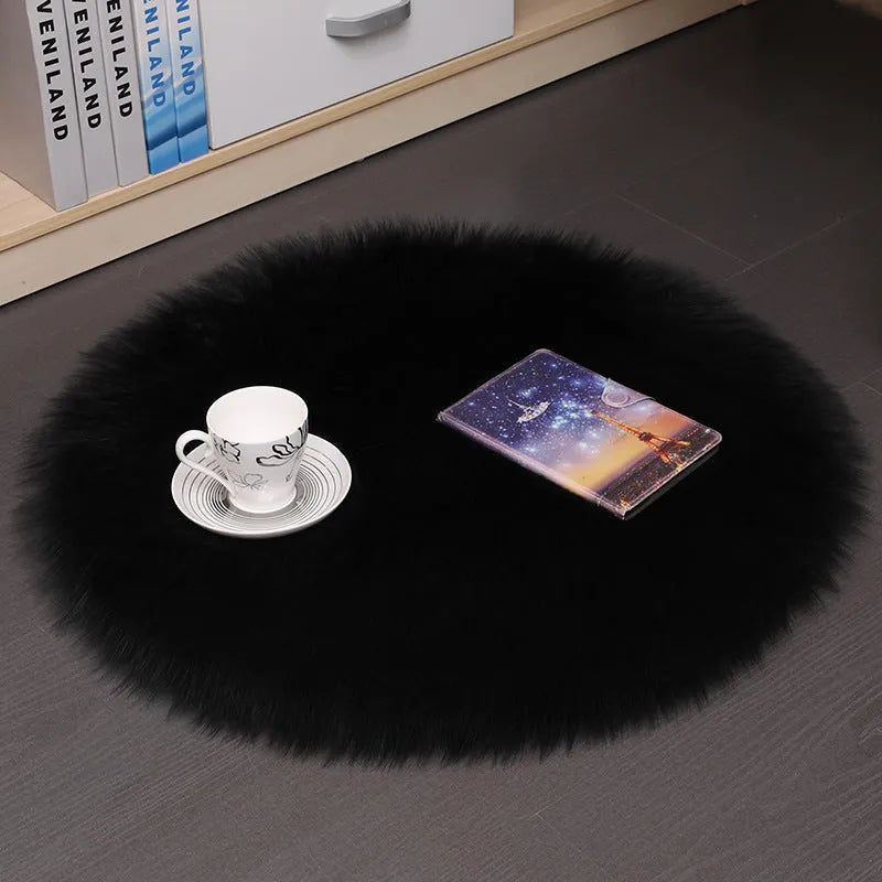 Round plush wool carpet in beige colour on a wooden floor.