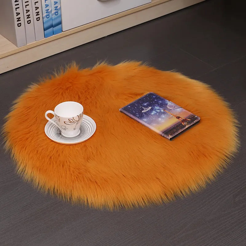 Round plush wool carpet in beige colour on a wooden floor.