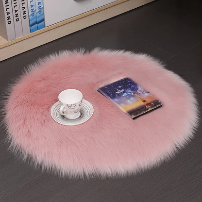 Round plush wool carpet in beige colour on a wooden floor.