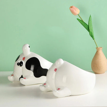 Stylish ceramic pet bowls in various cat-inspired designs, featuring inclined mouths for comfortable eating and large capacities for food and water.