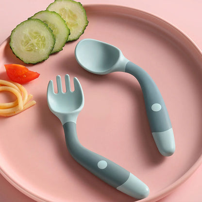 Flexible silicone baby spoon and fork set with ergonomic design for toddlers to learn self-feeding comfortably