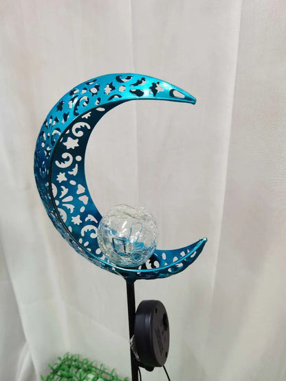 Blue hollow moon-shaped solar garden light with wrought iron frame and crackled glass ball.