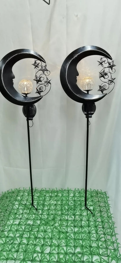 Blue hollow moon-shaped solar garden light with wrought iron frame and crackled glass ball.
