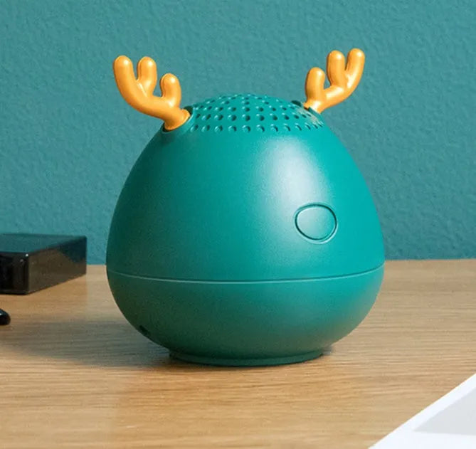 Small white, pink, or green portable Bluetooth speaker with USB cable.