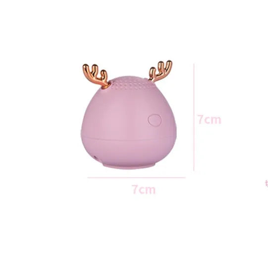 Small white, pink, or green portable Bluetooth speaker with USB cable.