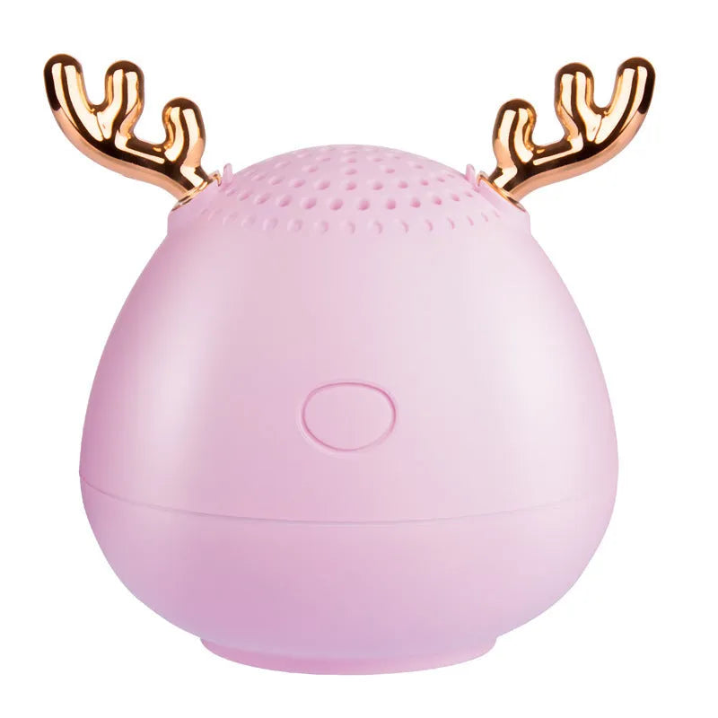 Small white, pink, or green portable Bluetooth speaker with USB cable.