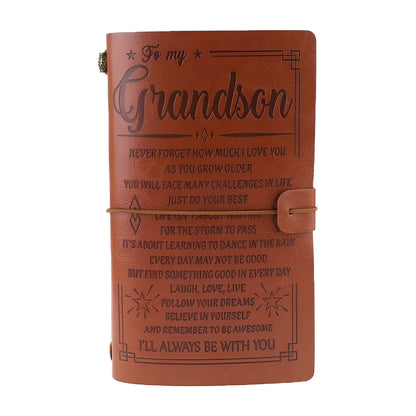 Leather cover business notebook with strap binding, open on warm brown acid-free paper.
