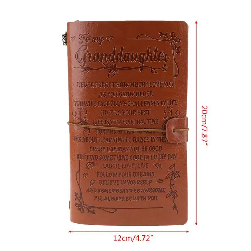Leather cover business notebook with strap binding, open on warm brown acid-free paper.