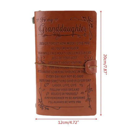 Leather cover business notebook with strap binding, open on warm brown acid-free paper.
