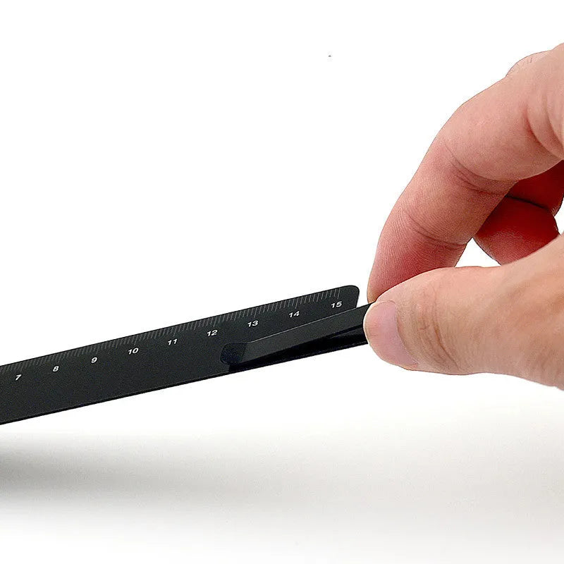 Aluminum bookmark ruler showing 15cm scale with laser-engraved markings in retro design