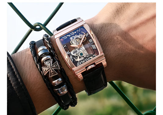Daystar square stainless steel mechanical watch with leather strap on wrist, showing white dial and case.