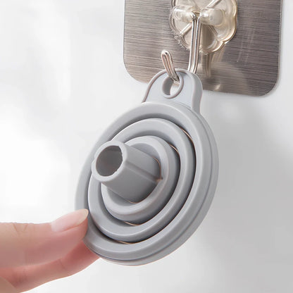 Grey silicone folding funnel collapsed to 2.5cm thickness beside expanded 18cm diameter version