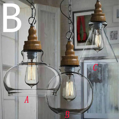 Glass single head pendant light with wood grain finish and adjustable cord.