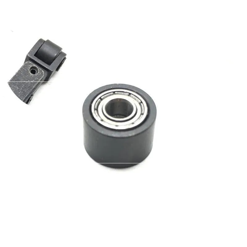 Metal pneumatic belt machine accessory kit with 330mm and 520mm rollers, blades, springs, and couplings on a workbench.