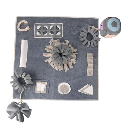 A grey snuffle pad with a soft, plush surface for hiding treats to stimulate a pet's natural foraging skills.
