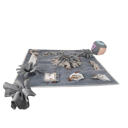 A grey snuffle pad with a soft, plush surface for hiding treats to stimulate a pet's natural foraging skills.