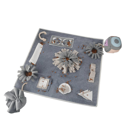 A grey snuffle pad with a soft, plush surface for hiding treats to stimulate a pet's natural foraging skills.