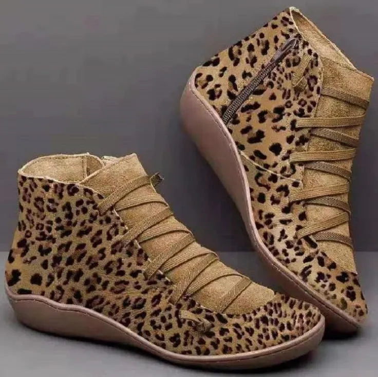 Women's casual booties with wedge heel and round toe in various colours like black and leopard print, showing rubber sole.