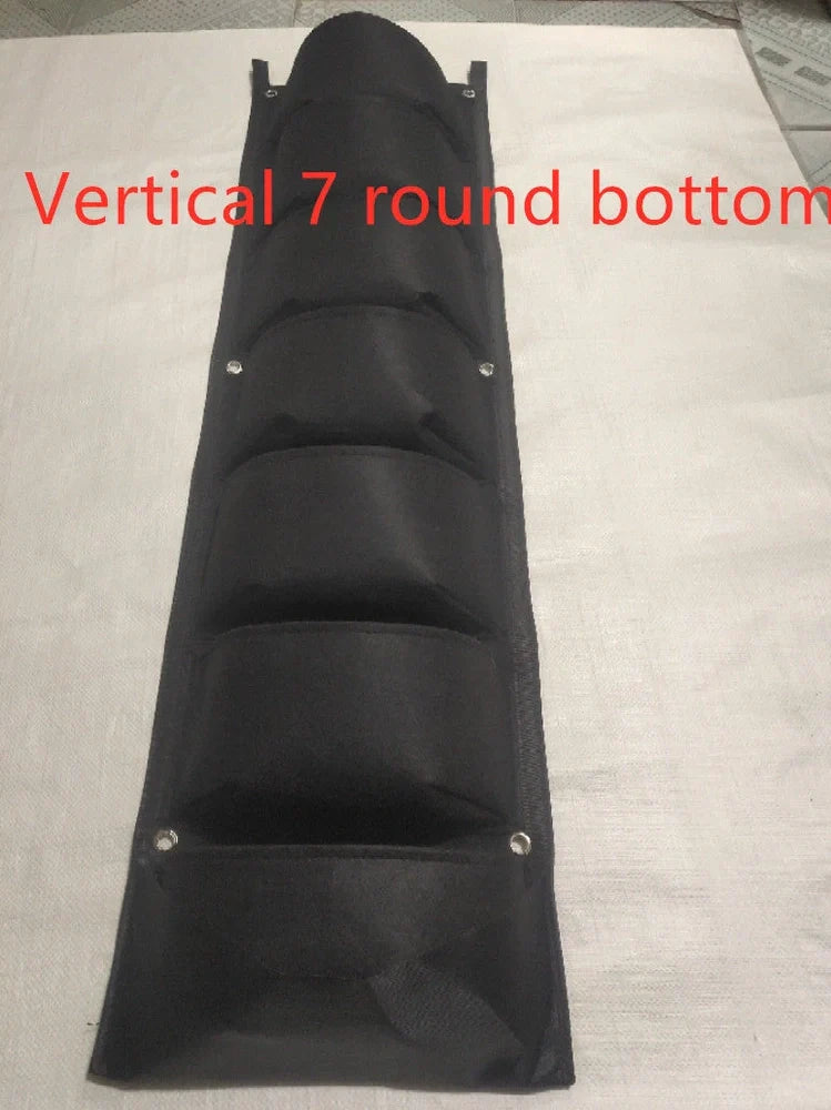 Vertical wall garden planting bag with 18 pockets hanging on outdoor wall with growing herbs